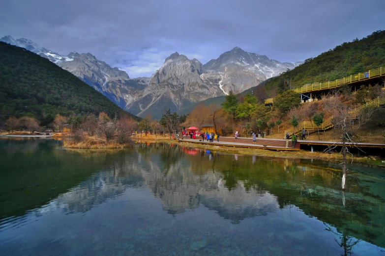 a river running between mountains that have a bunch of people on it