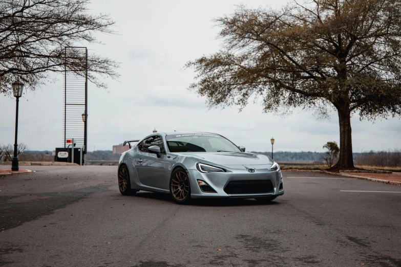 a silver sports car parked on a street