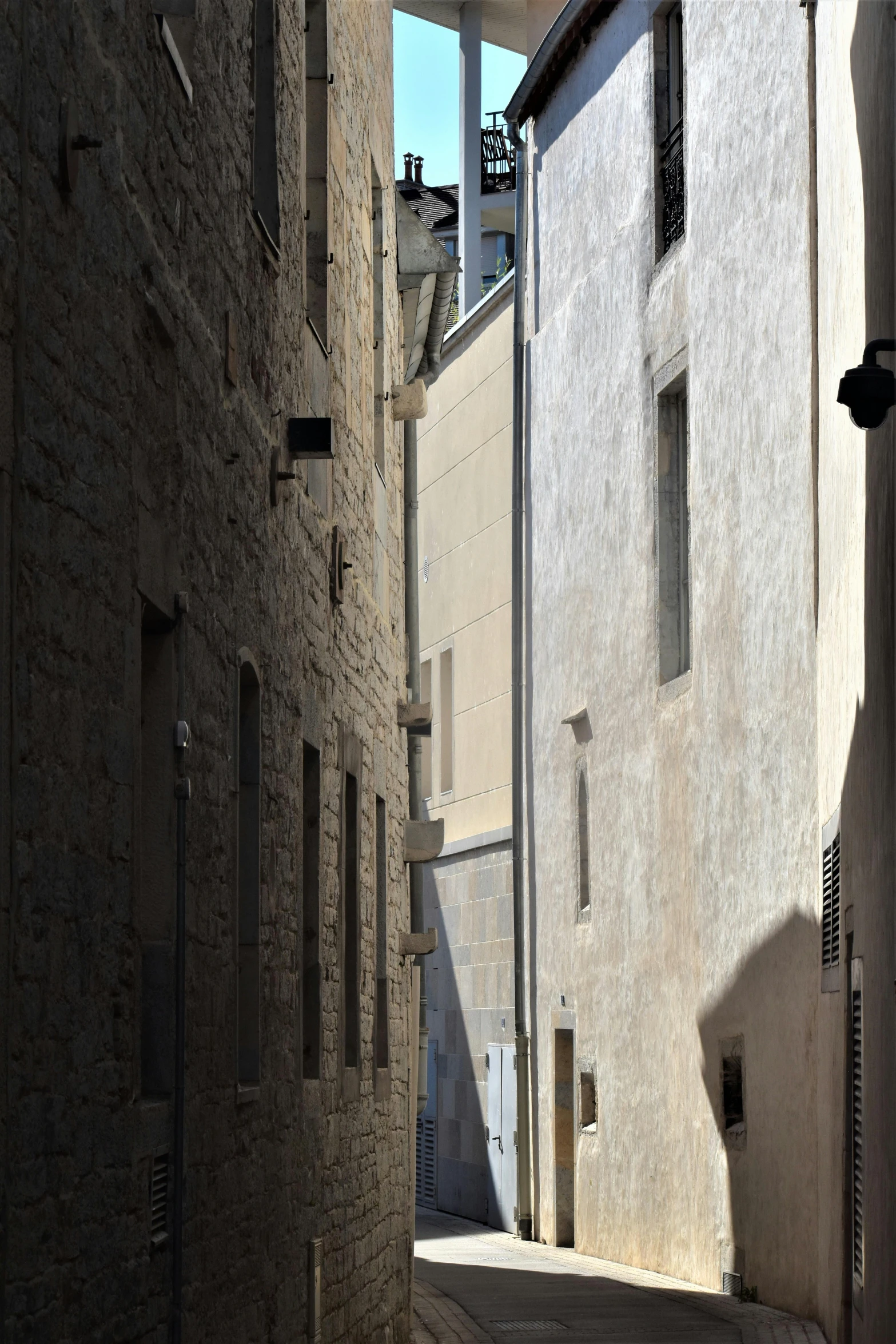 the shadow of a person in an alley way