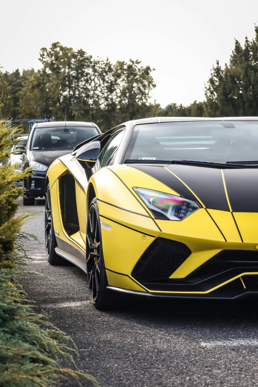 yellow sports car driving down a city street