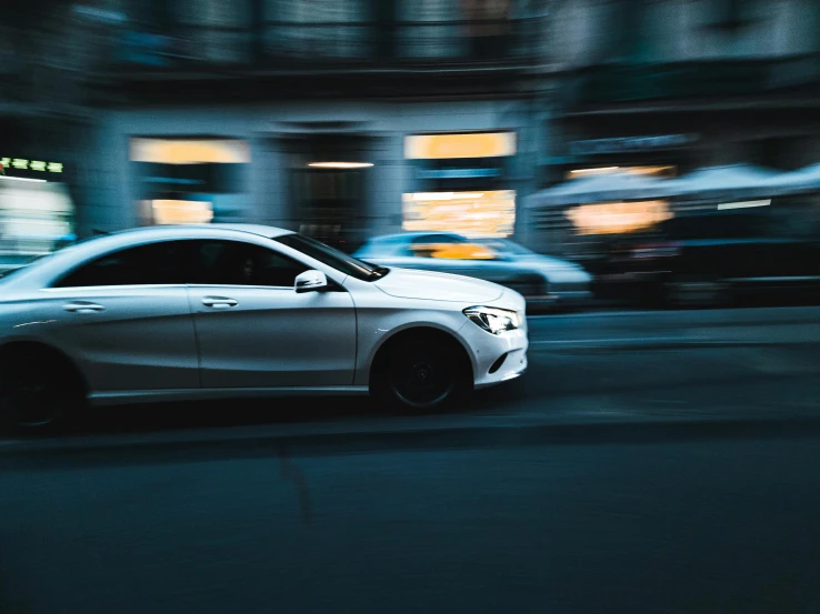 a white car is parked in the street