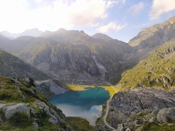 a mountain view showing a placid lake surrounded by some rocks