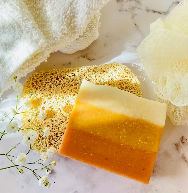 soap bar and flowers on a marble surface