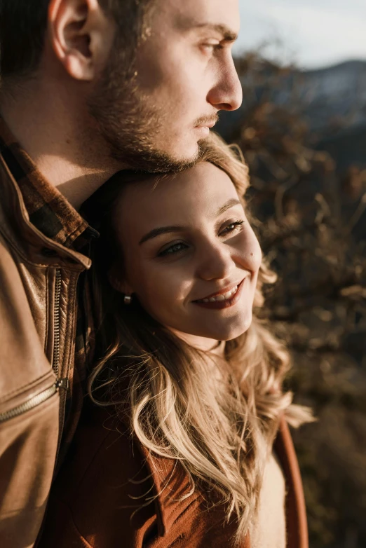 a close up of a man and woman smiling