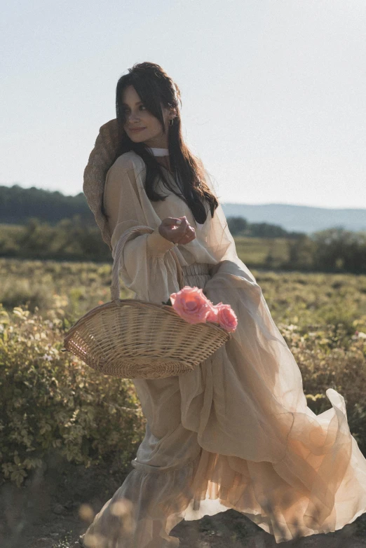 a young woman is walking in a field