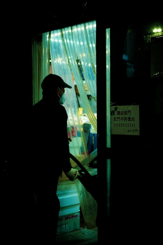 a man with an umbrella standing in front of a door