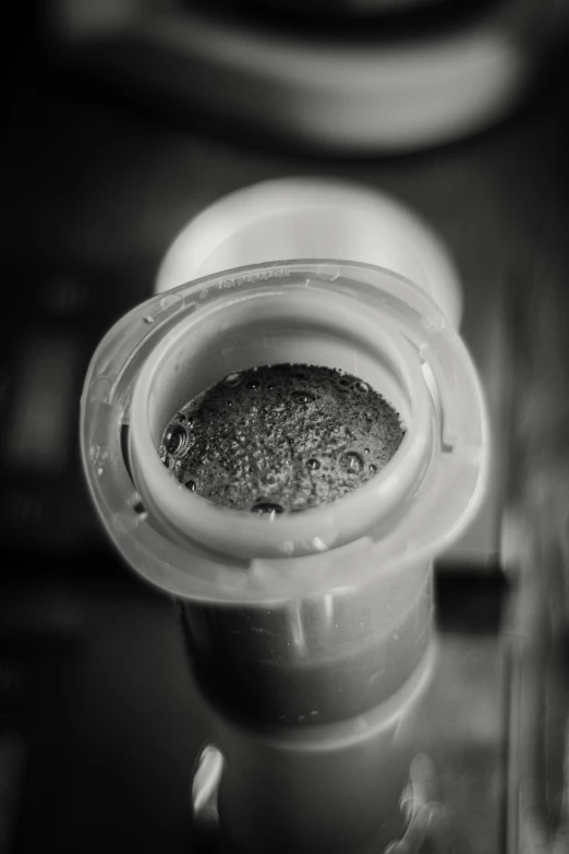 a small grinder with a bowl next to it on top of a table