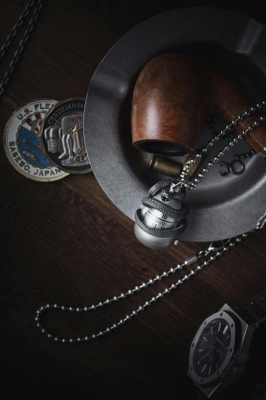 an assortment of jewelry and watch parts are arranged on a table