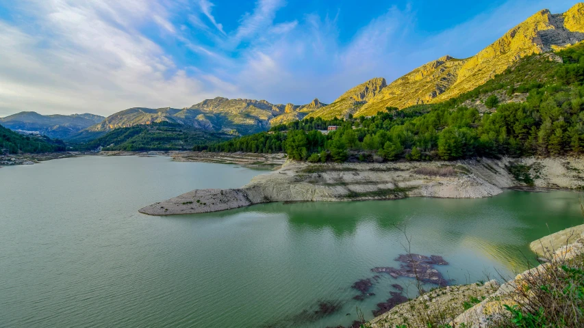 the water is crystal clear and reflects the beautiful mountain scenery