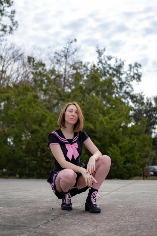 a girl sits on the ground wearing pink tights