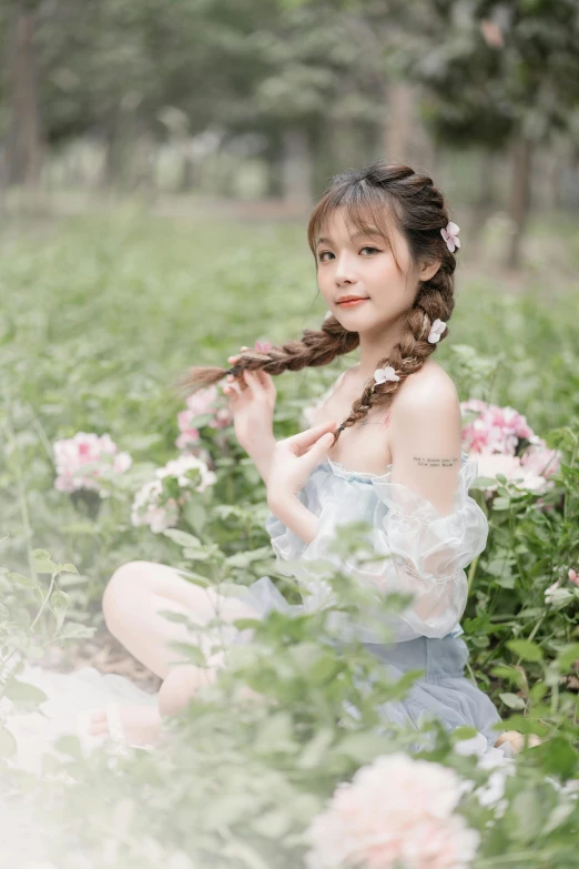 woman sitting in flowers with long hair