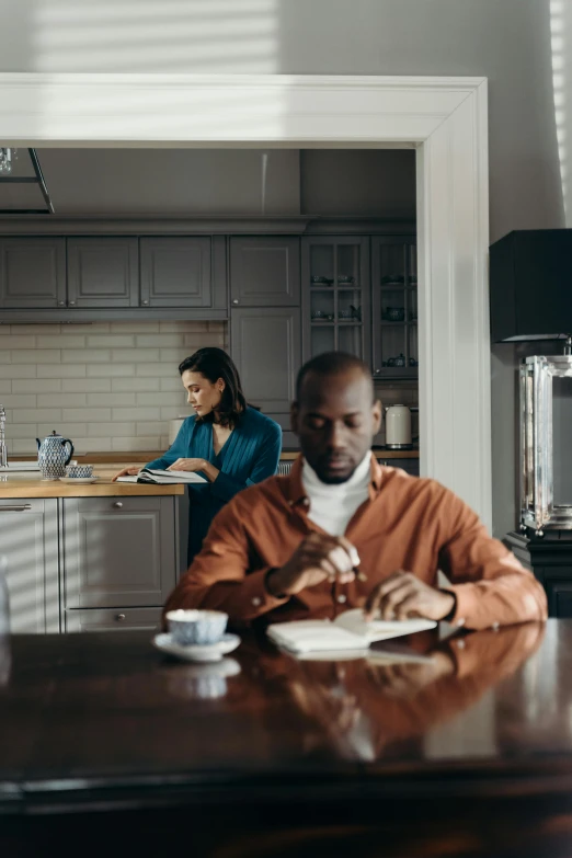 a couple is standing around in their kitchen