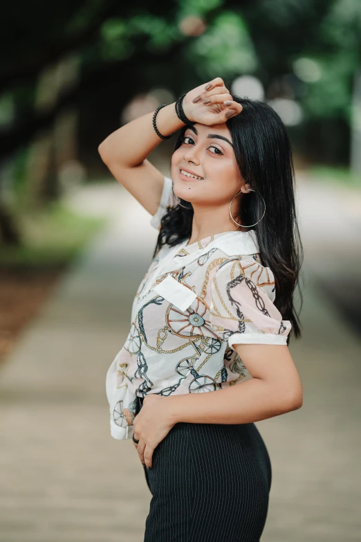 a woman posing for the camera in a park