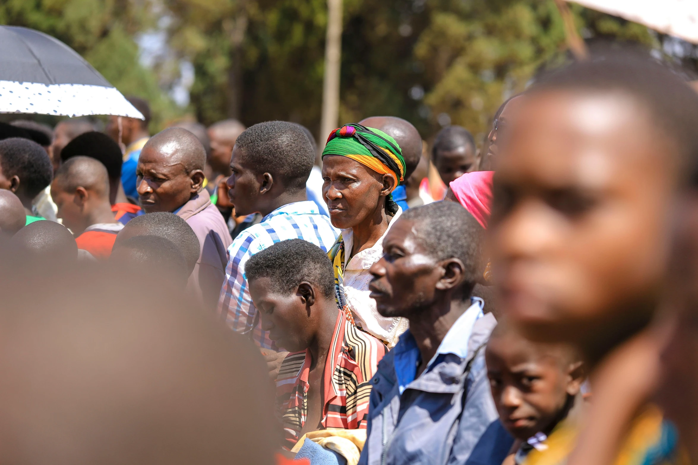 a crowd of people standing around one another