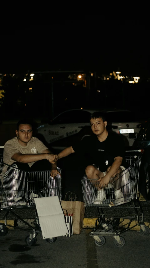 two men sitting in the back of a pick up truck