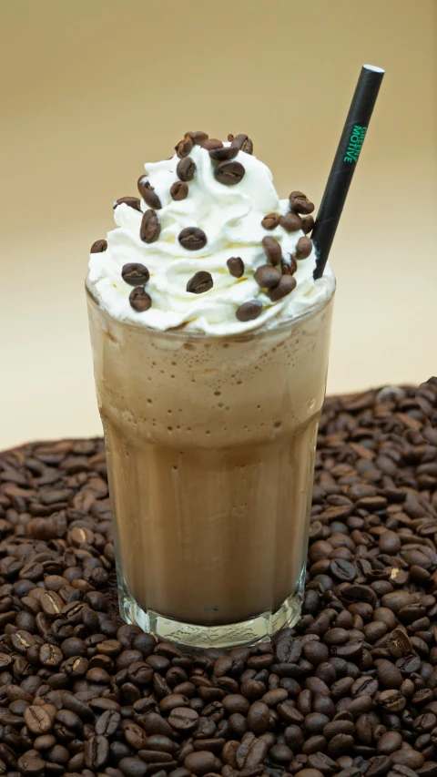 a cup with a drink and some chocolate beans on it