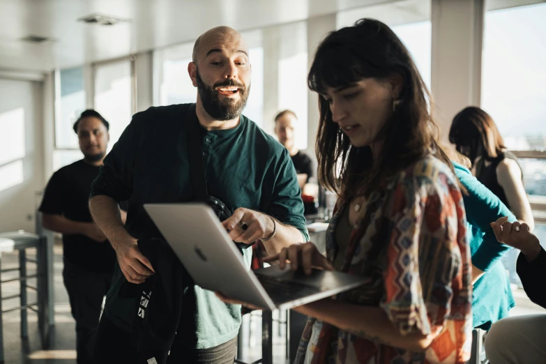 a man and woman standing together using electronic devices