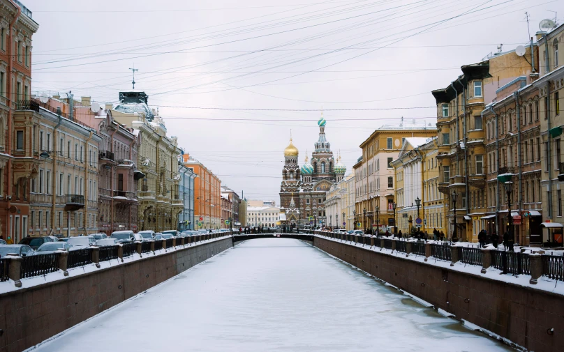 snow blankets a street with buildings on both sides