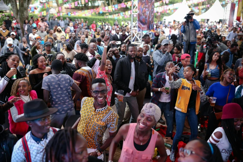 a crowd of people standing next to each other