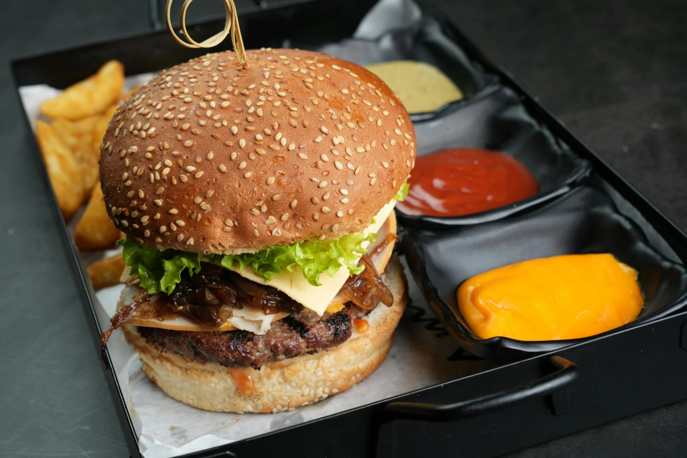 a tray with a hamburger and fries in it