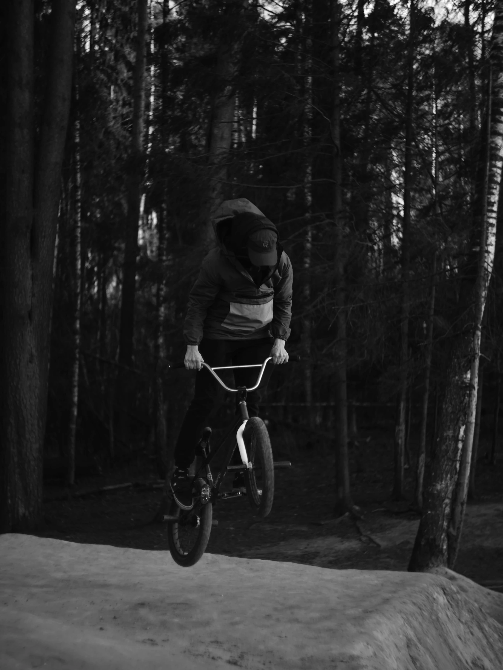 a man riding a bicycle through the woods