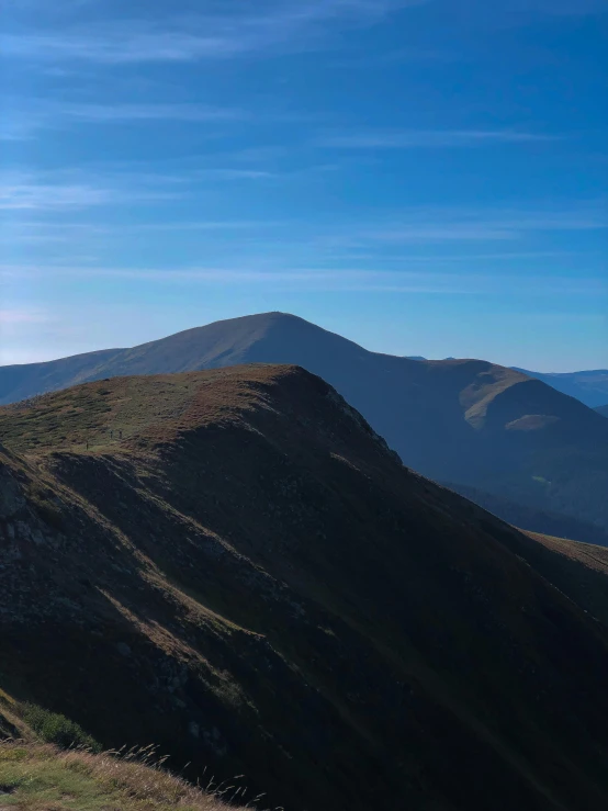 the sun shining bright on top of the mountains