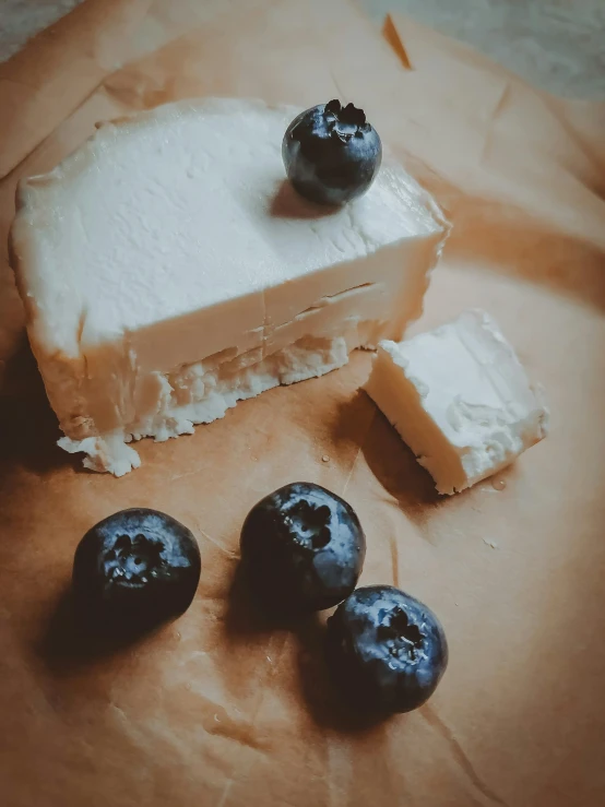 blueberries and piece of cake on a table