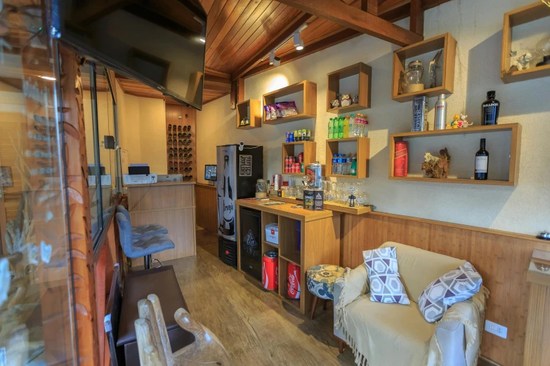 a coffee shop with lots of shelves, chairs and bottles