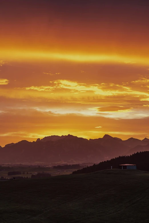 sunset view with trees and mountains in distance