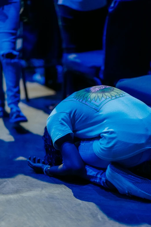 a man kneeling on the floor of a arena