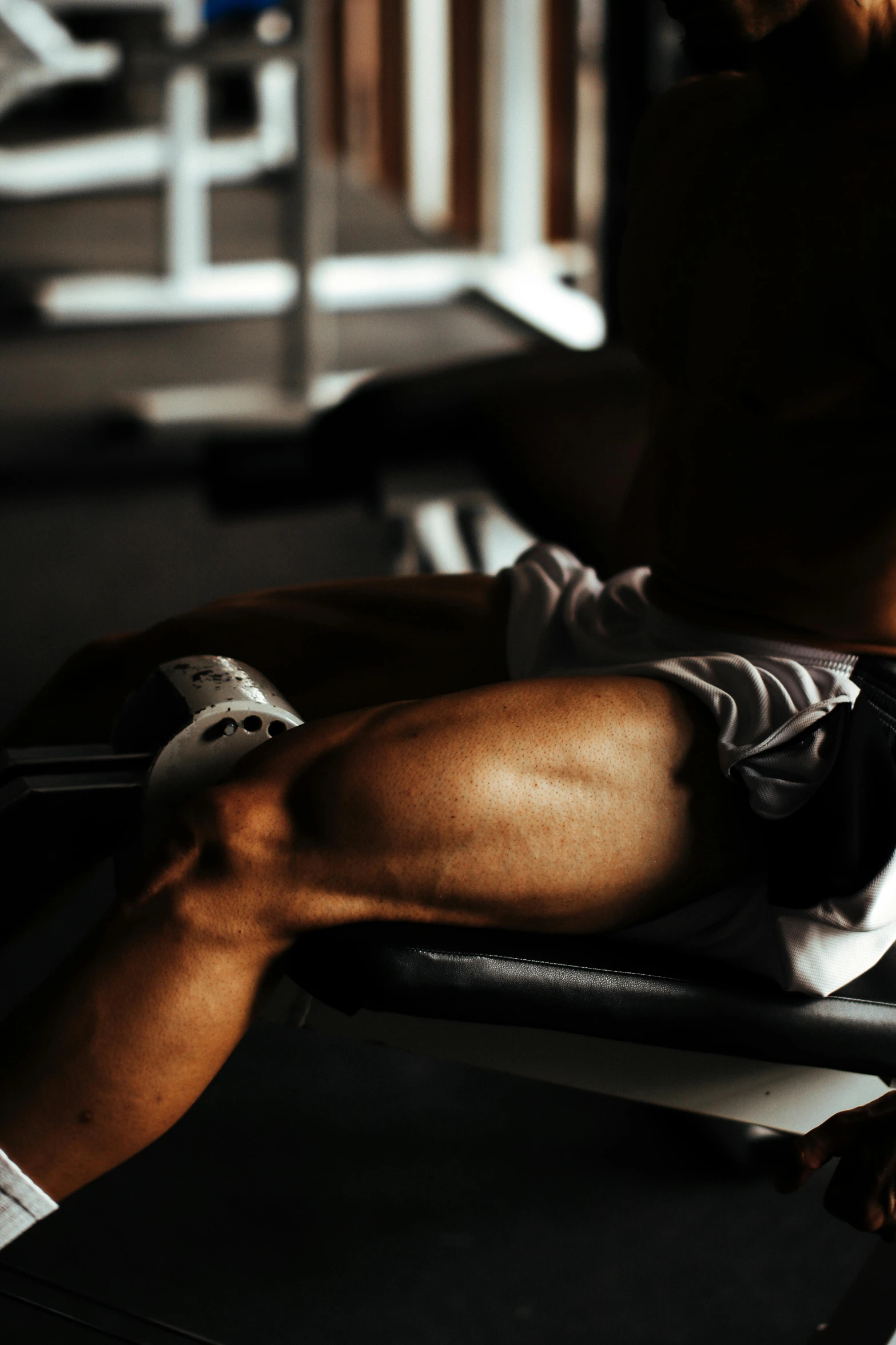 man doing sit up exercises with machine in gym