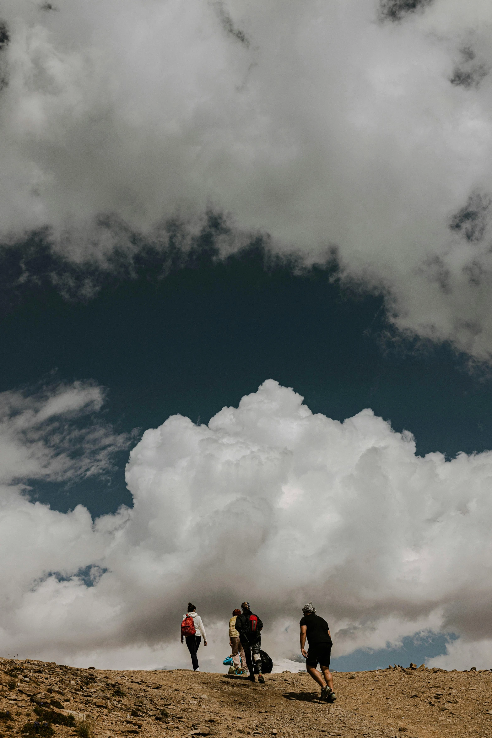 a group of people standing next to each other flying a kite