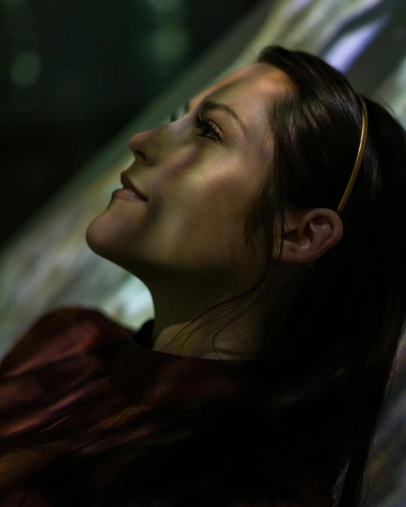 a beautiful woman with a long ponytail sitting down