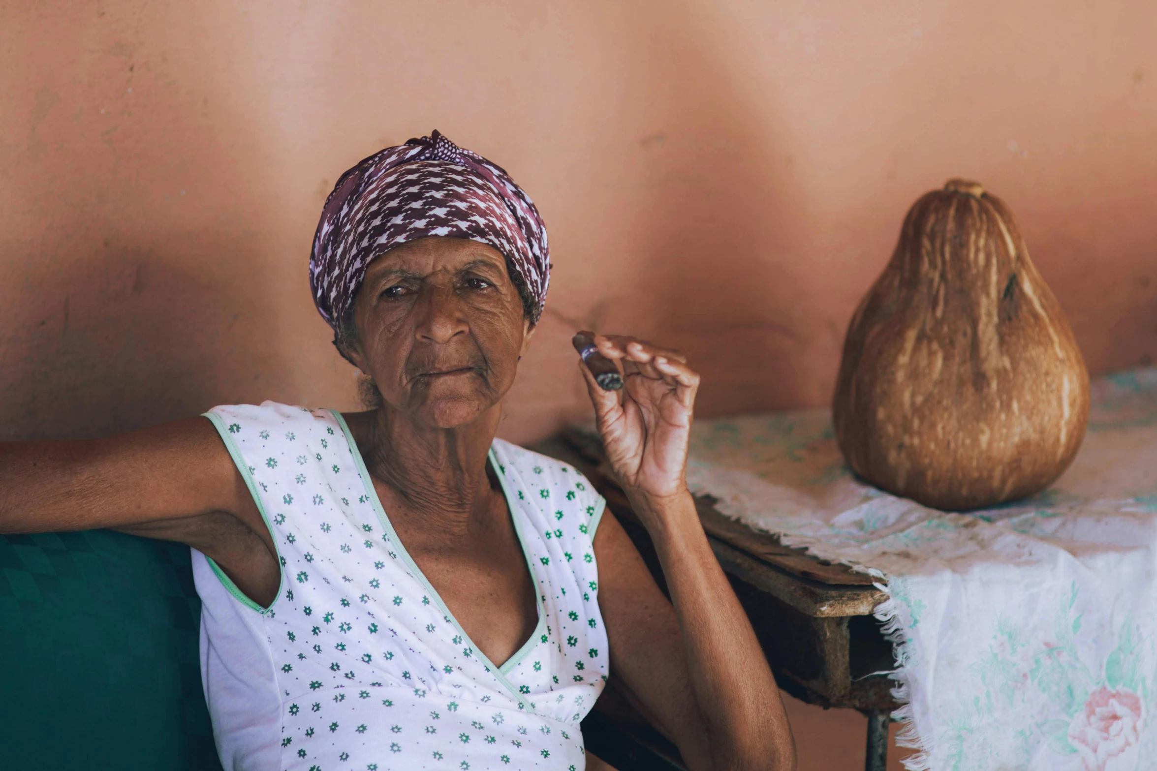 a woman in a white top sitting in a chair