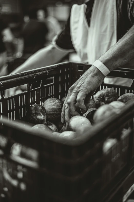 man holding a basket filled with apples on the side