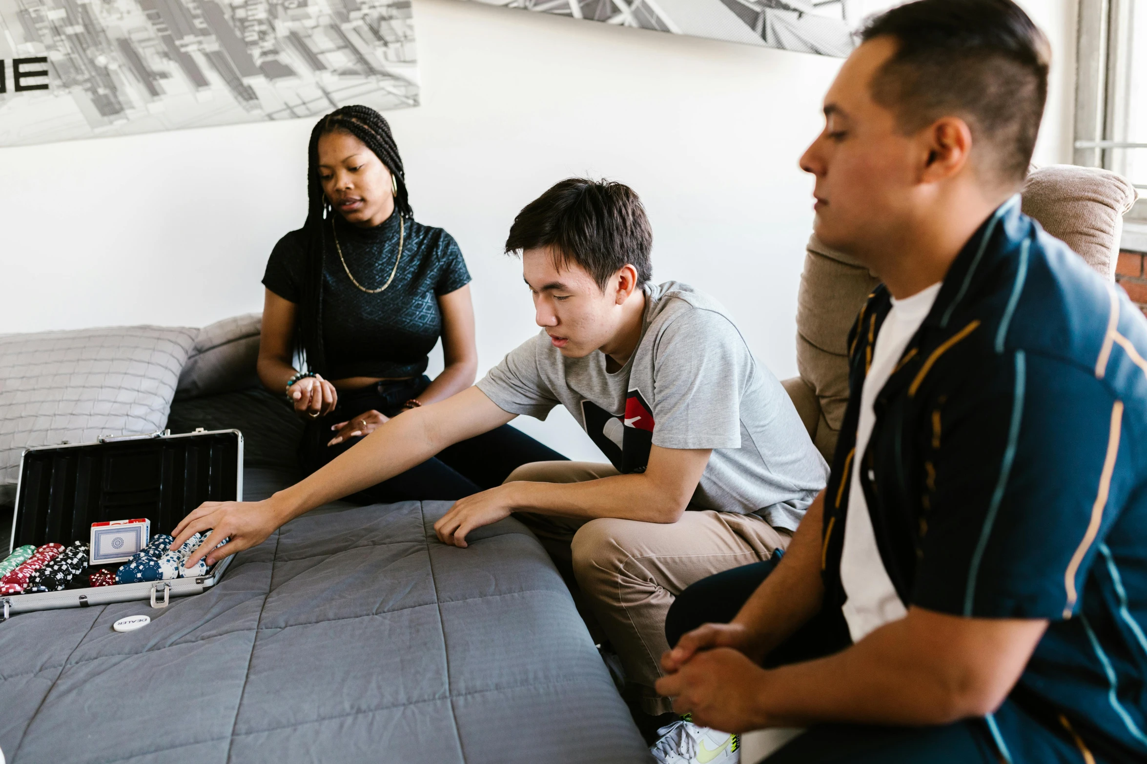 group of adults playing with mini robot on table