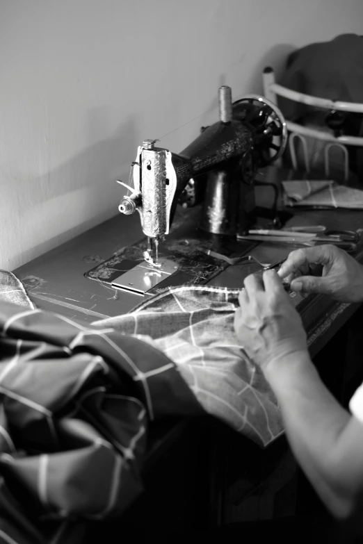 the lady is sewing with her sewing machine