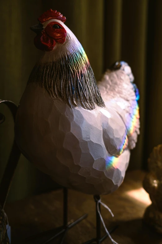 a colorful chicken stands next to a wall