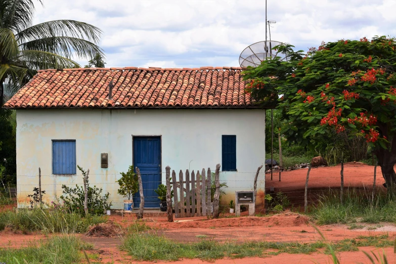 the small house has blue doors and a brown roof