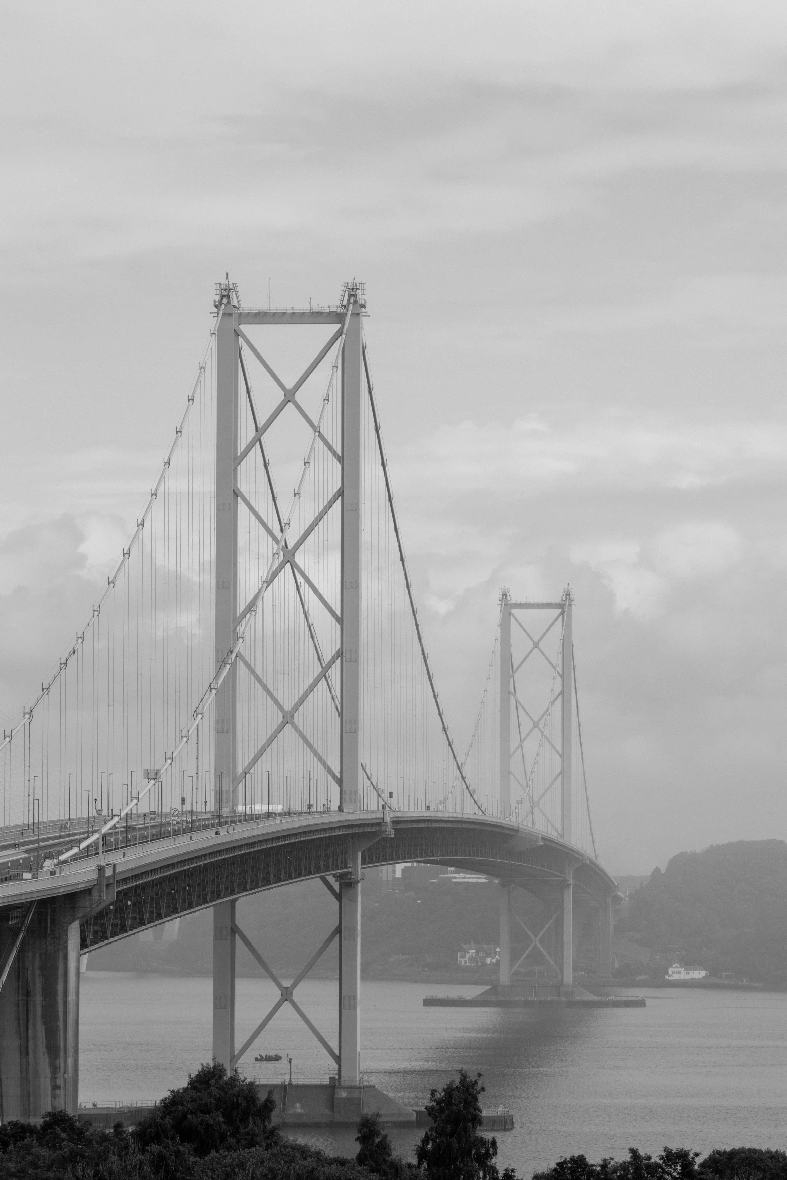 black and white pograph of a bridge across the water