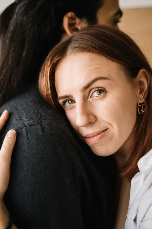 the woman is hugging her boyfriend in front of the camera