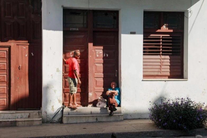 there is a boy and a girl outside of a building