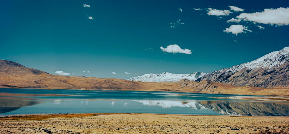 a large body of water in the middle of mountains