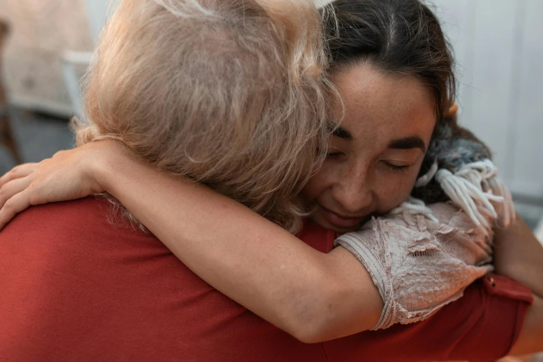 a mother holds her child while she hugs her face