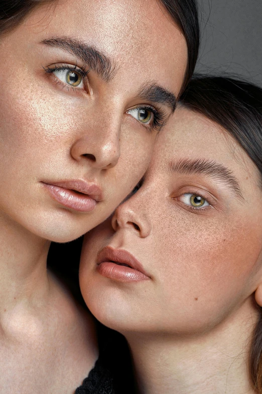 two beautiful women who are both wearing makeup