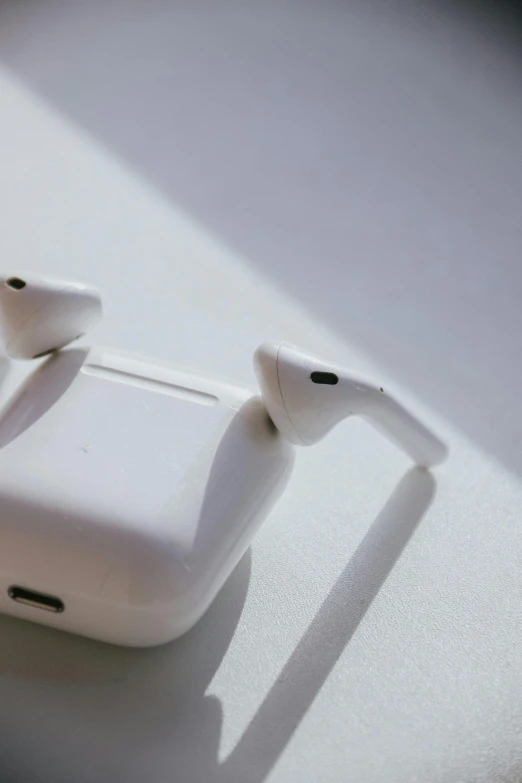 an apple airpods that is charging on a surface