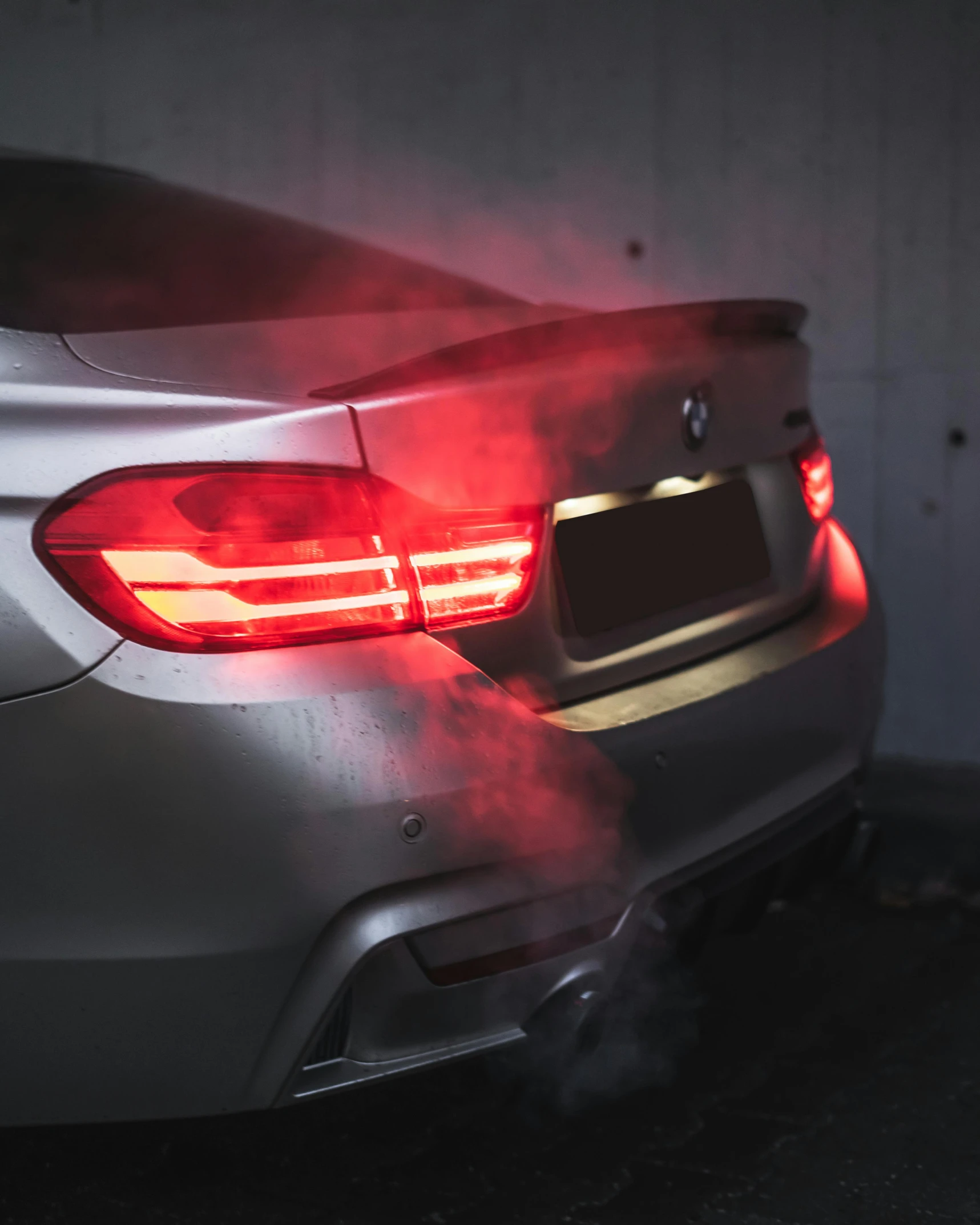 a shiny metallic bmw car in the garage