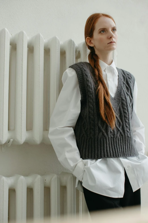 a woman with id standing next to a radiator