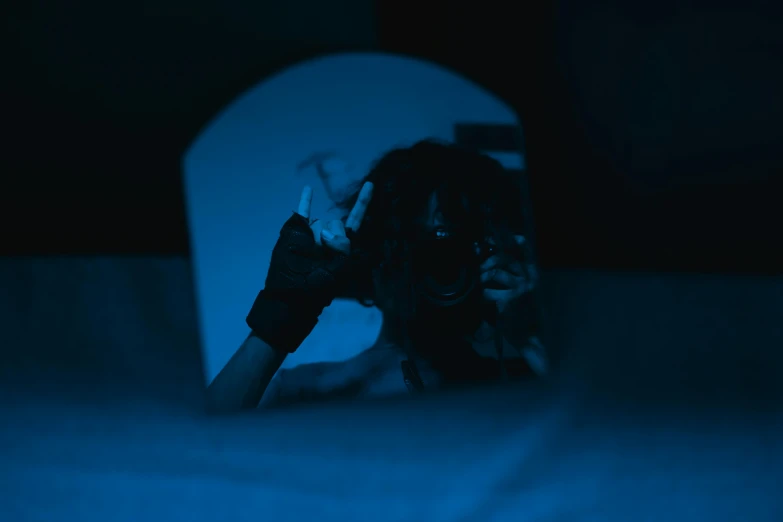 a woman sitting on a toilet seat in a dark room