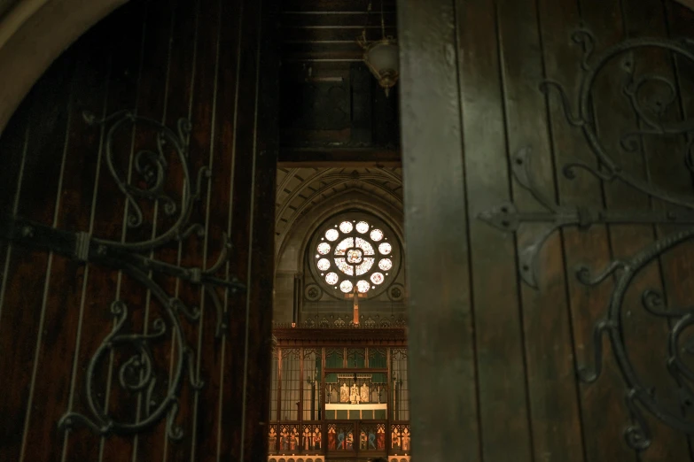 a large wooden door with a clock above it